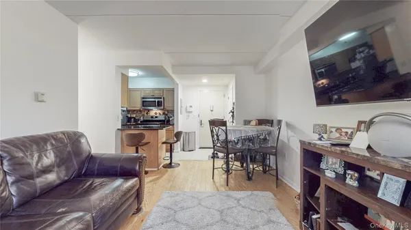 a living room with furniture a dining table and kitchen view
