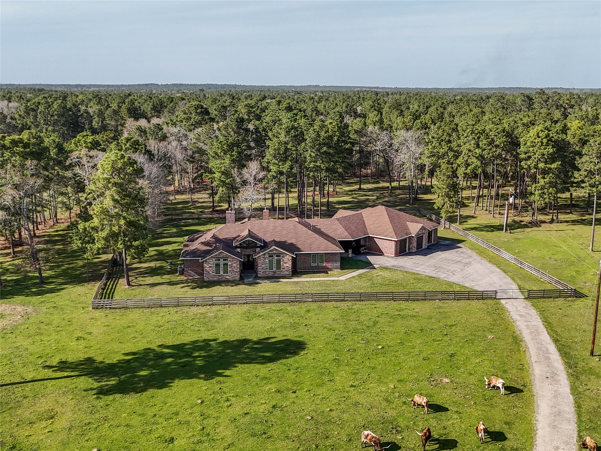 Set among wide open green pastures, this custom home offers a fenced yard, private driveway, and peaceful natural surroundings that capture the essence of country living.