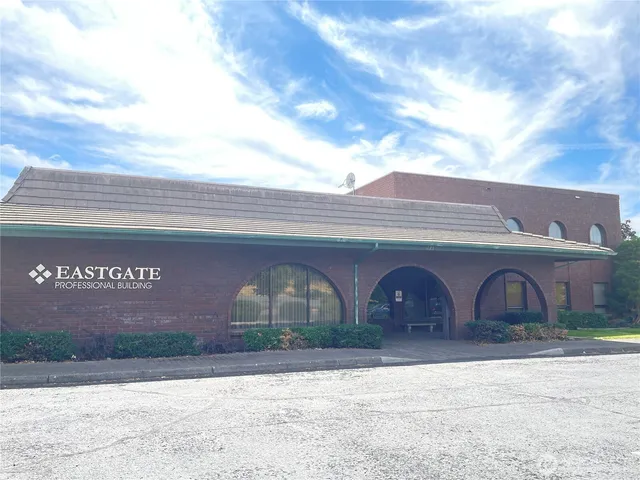 a front view of building with parking