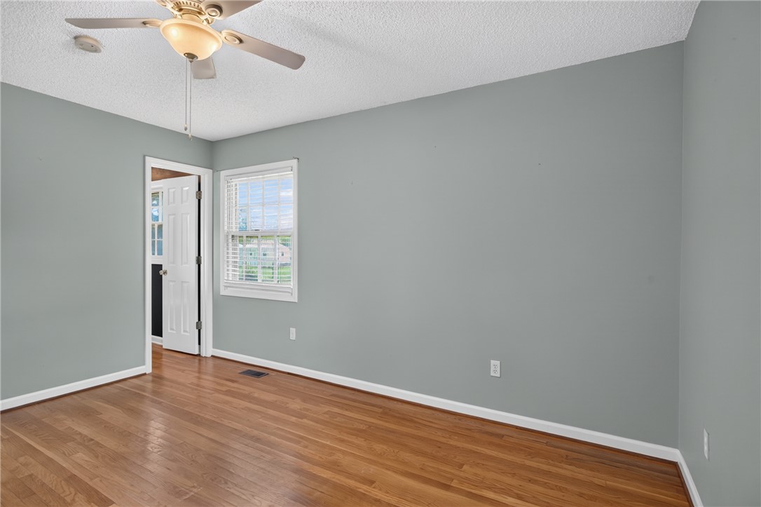 113 Greenfield Avenue Pendleton, SC 29670 - Photo 15 of 40 Rich hardwood flooring creates a welcoming ambiance in this well-lit room.