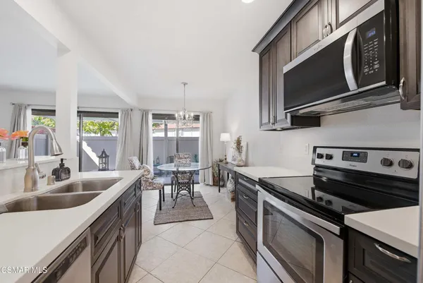 a kitchen with a sink stove and microwave