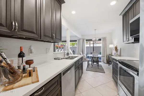 a kitchen with stainless steel appliances granite countertop a sink stove and cabinets