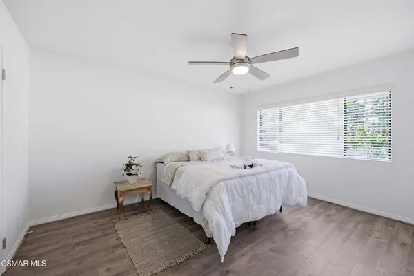 a spacious bedroom with a bed and a window