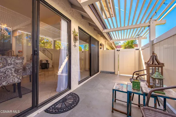 a view of a porch with furniture and a yard