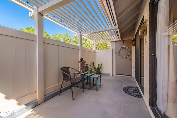 a view of a white house with a large space and city view