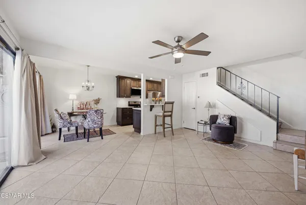a view of kitchen with furniture and ceiling fan