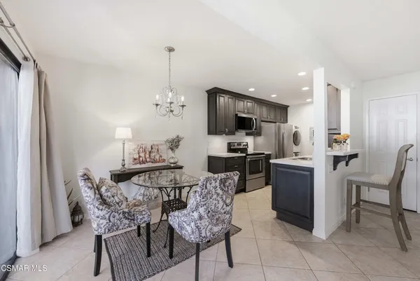 a view of a dining room with furniture and a chandelier