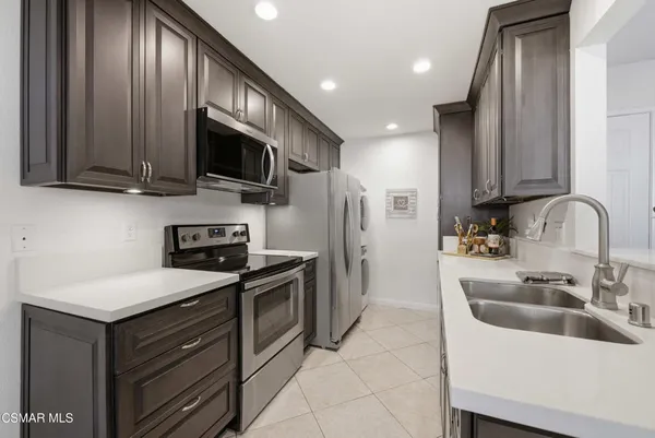 a kitchen with stainless steel appliances sink a microwave and cabinets