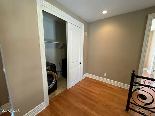 an empty room with wooden floor and closet