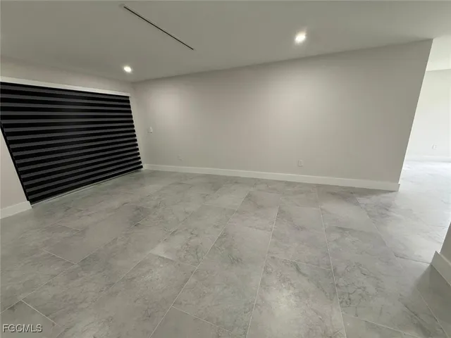 a view of an empty room with a fireplace