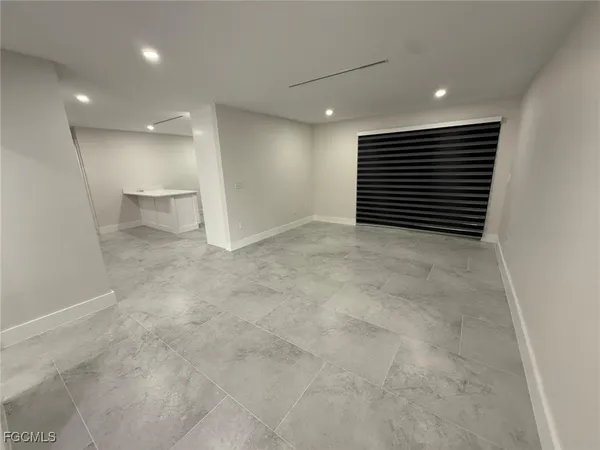 a view of an empty room with a bathroom