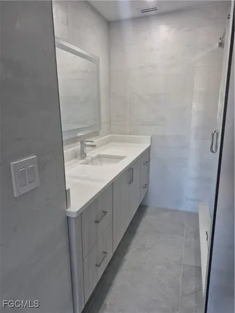 a bathroom with a double vanity sink and a mirror
