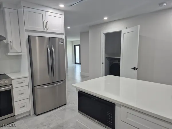 a kitchen with stainless steel appliances a refrigerator and cabinets