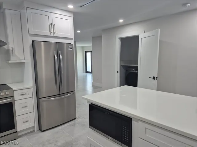 a kitchen with stainless steel appliances a refrigerator and cabinets