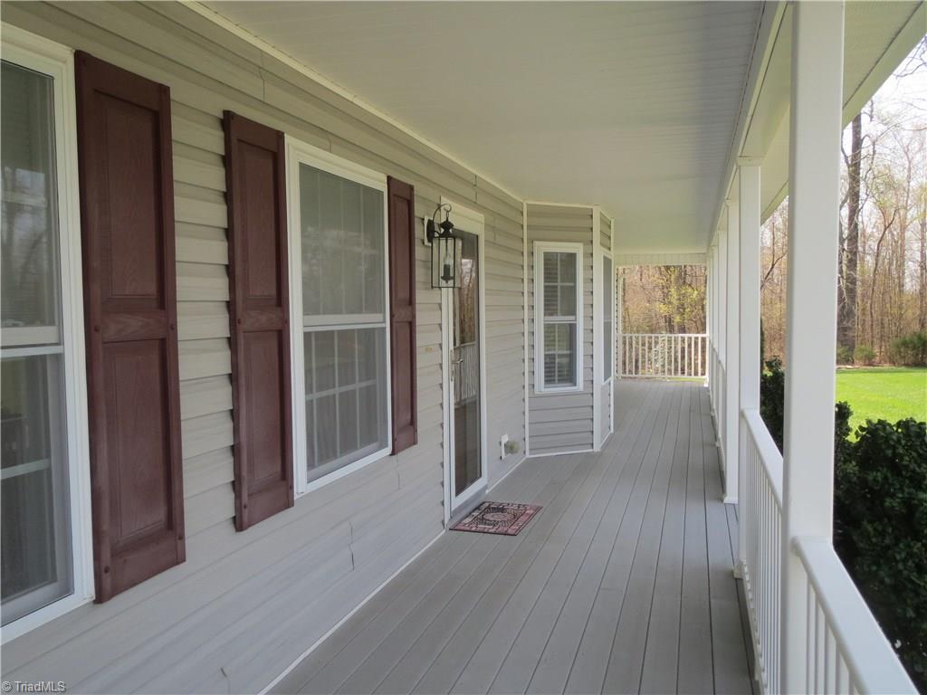 2212 Little Elkin Church Road Ronda, NC 28670 - Photo 2 of 30 Covered front porch great for rocking chairs to enjoy outdoors. Durable decking for easy maintenance.