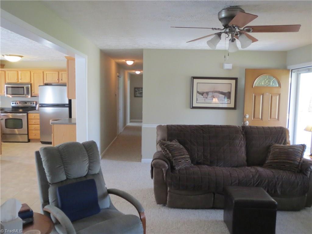 2212 Little Elkin Church Road Ronda, NC 28670 - Photo 12 of 30 Welcome home! View of living room, looking toward kitchen and hallway leading to bedrooms and baths.