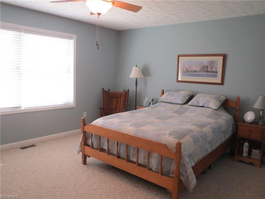 2212 Little Elkin Church Road Ronda, NC 28670 - Photo 17 of 30 Spacious master bedroom with large windows overlooking back yard.