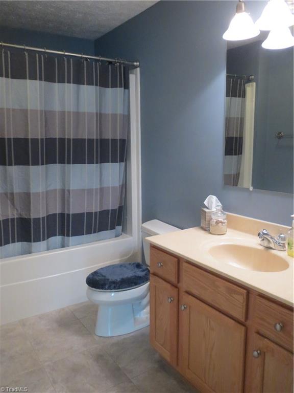 2212 Little Elkin Church Road Ronda, NC 28670 - Photo 22 of 30 Second bath features tile floor and shower/tub combination.
