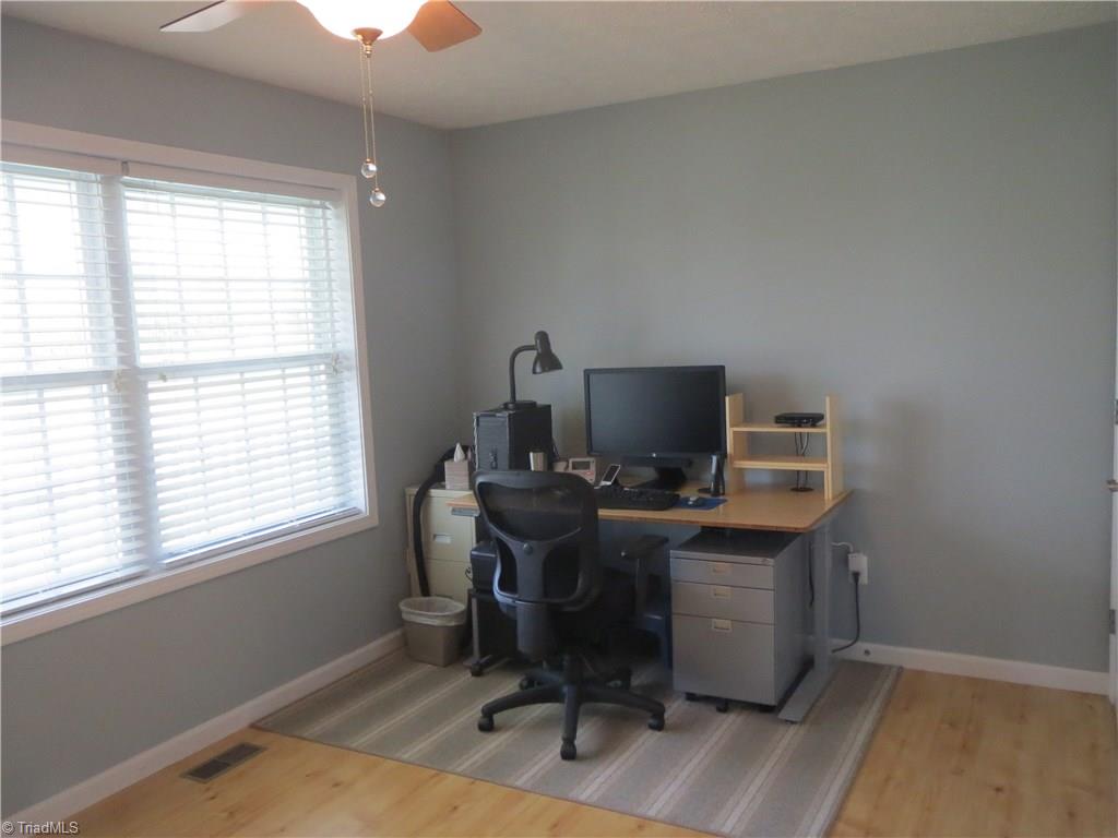 2212 Little Elkin Church Road Ronda, NC 28670 - Photo 23 of 30 Third bedroom features laminate faux wood flooring creating a versatile space for home office or bedroom.