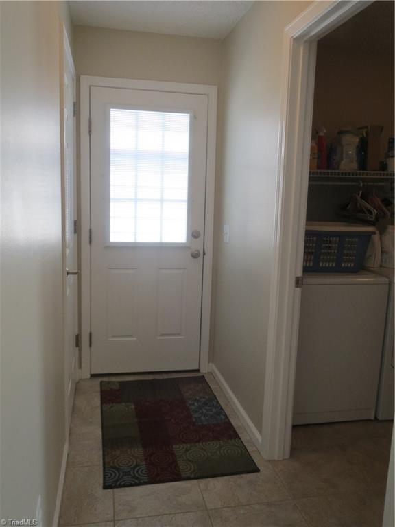 2212 Little Elkin Church Road Ronda, NC 28670 - Photo 24 of 30 Kitchen hallway leading to laundry room on right, carport straight ahead and basement door to left.