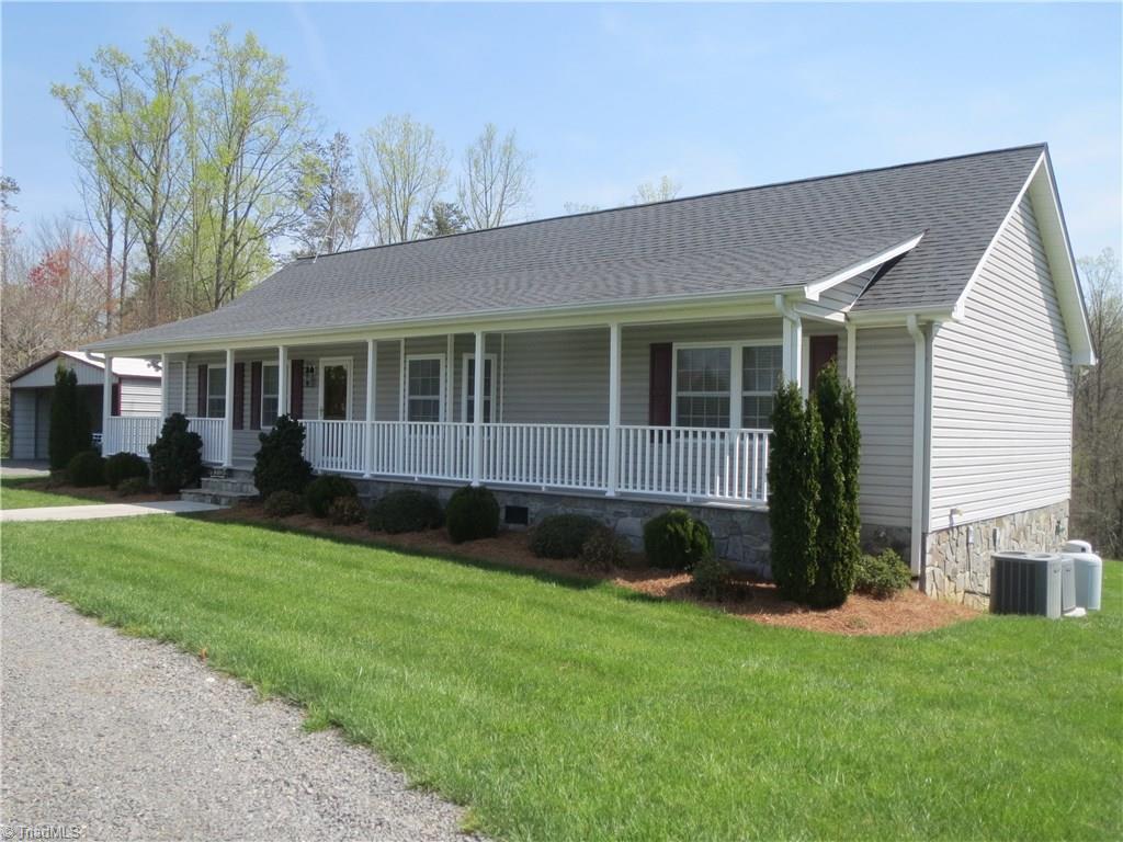 2212 Little Elkin Church Road Ronda, NC 28670 - Photo 4 of 30 Vinyl siding and stone covered foundation provide clean aesthetic and low maintenance.