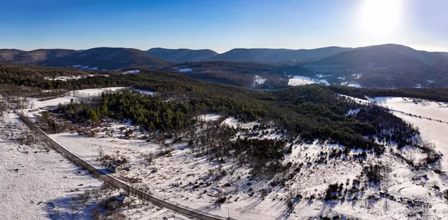 a view of ocean with a mountain