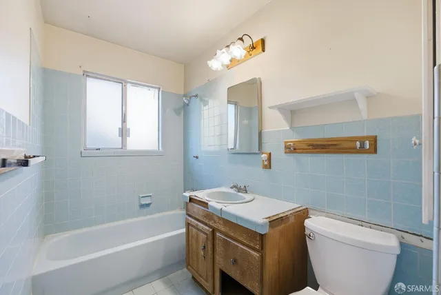 a bathroom with a sink a toilet and bathtub