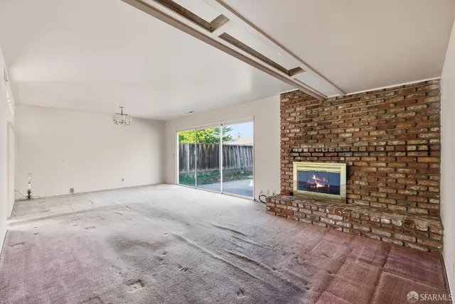 a view of empty room with a fireplace