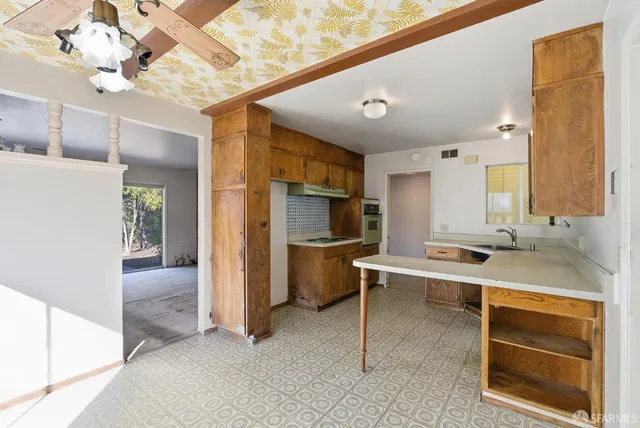 a view of a kitchen with a sink and cabinets