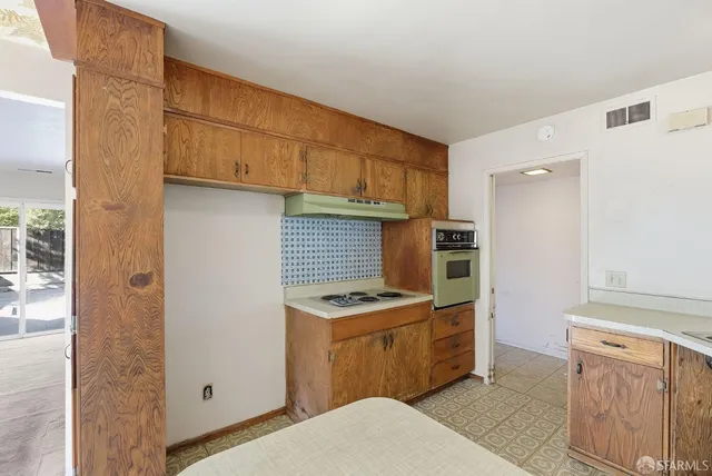 a kitchen with stainless steel appliances granite countertop a stove and a refrigerator
