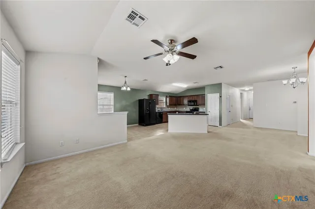 a view of a kitchen with a sink and a stove top oven