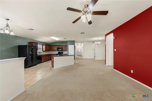 a view of a kitchen with a sink and a refrigerator