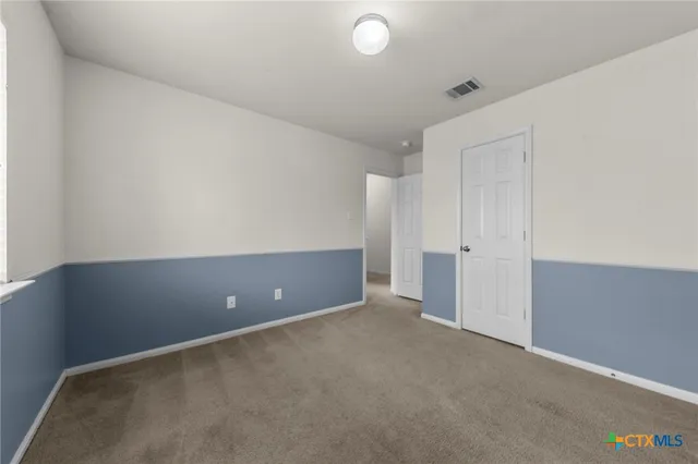 an empty room with an empty space and windows