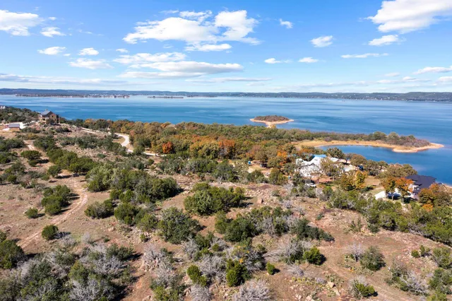 an aerial view of a house with a lake view