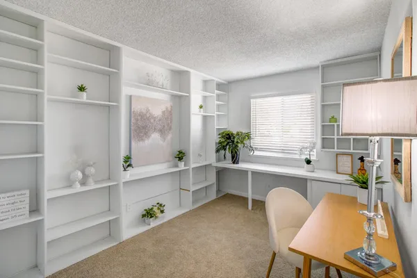 a large white kitchen with a window