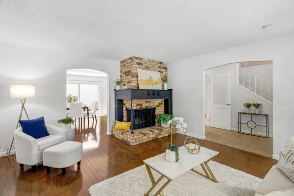 a living room with furniture and a fireplace