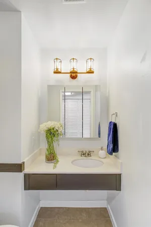 a patio with table and chairs and potted plants