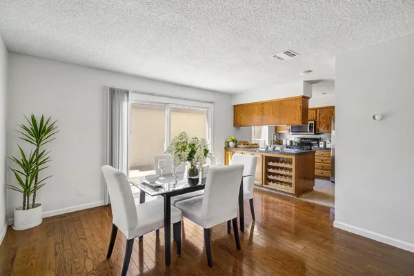 a kitchen with stainless steel appliances a sink cabinets and a window