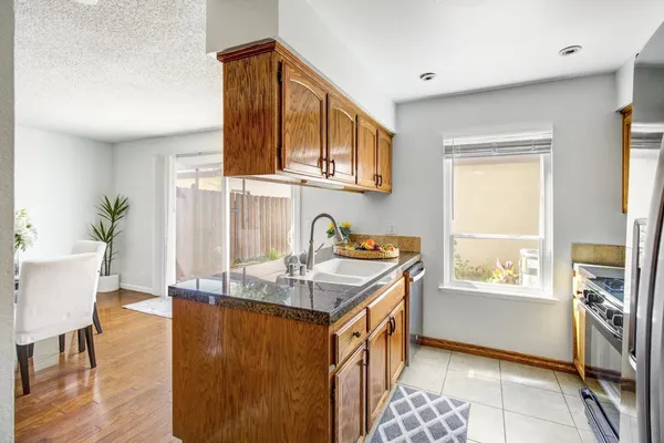 a kitchen with granite countertop a stove and a sink