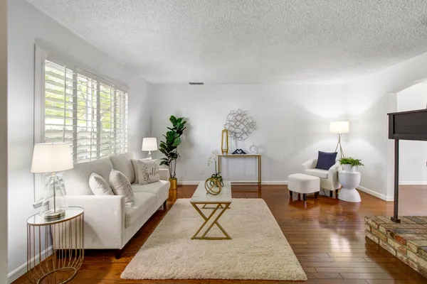 a living room with furniture and wooden floor