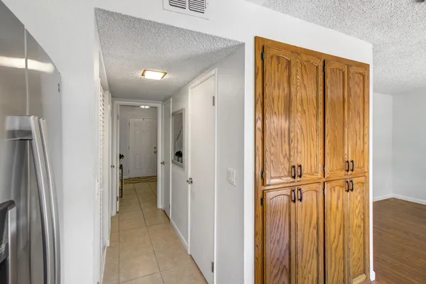 a view of a hallway with wooden shelves