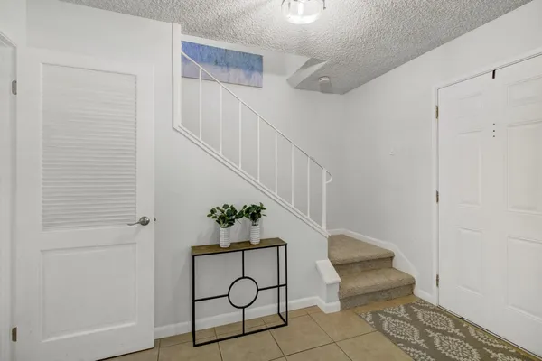 a view of entryway with wooden floor and stairs