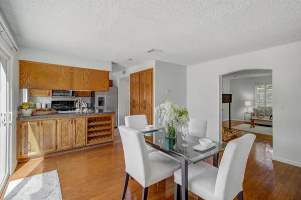 a dining room with furniture a window and kitchen view