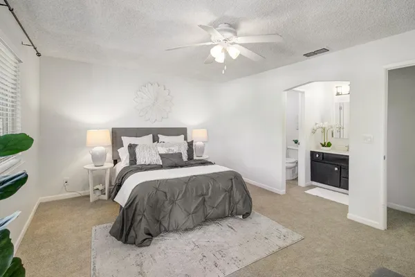 a bedroom with a bed and a chandelier