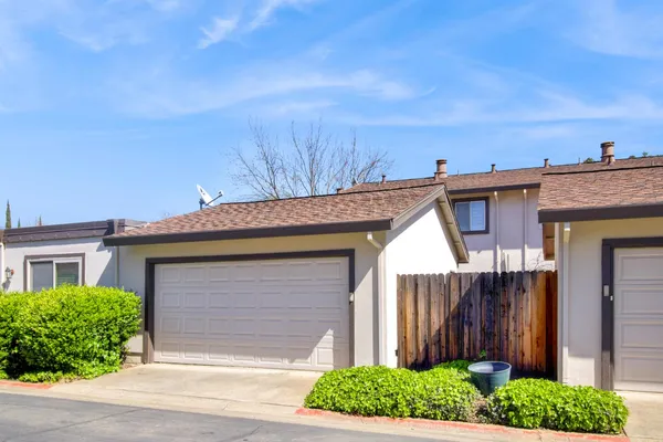 a view of a house with wooden fence