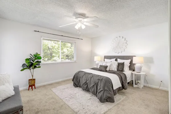 a bedroom with a bed and chandelier