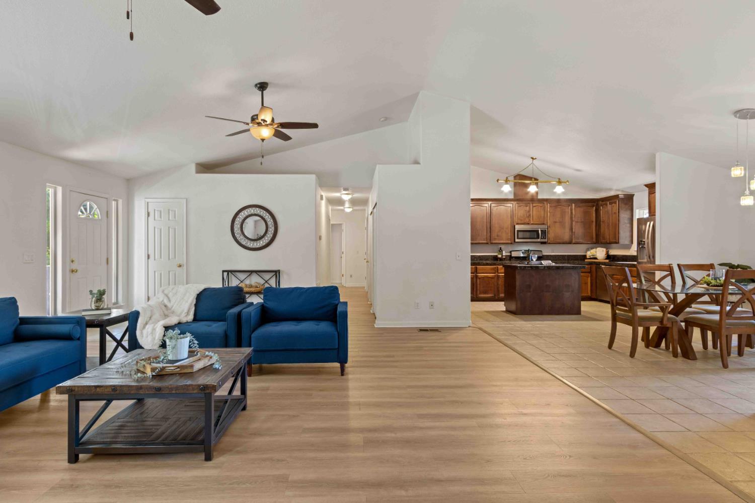 a living room with furniture and kitchen view