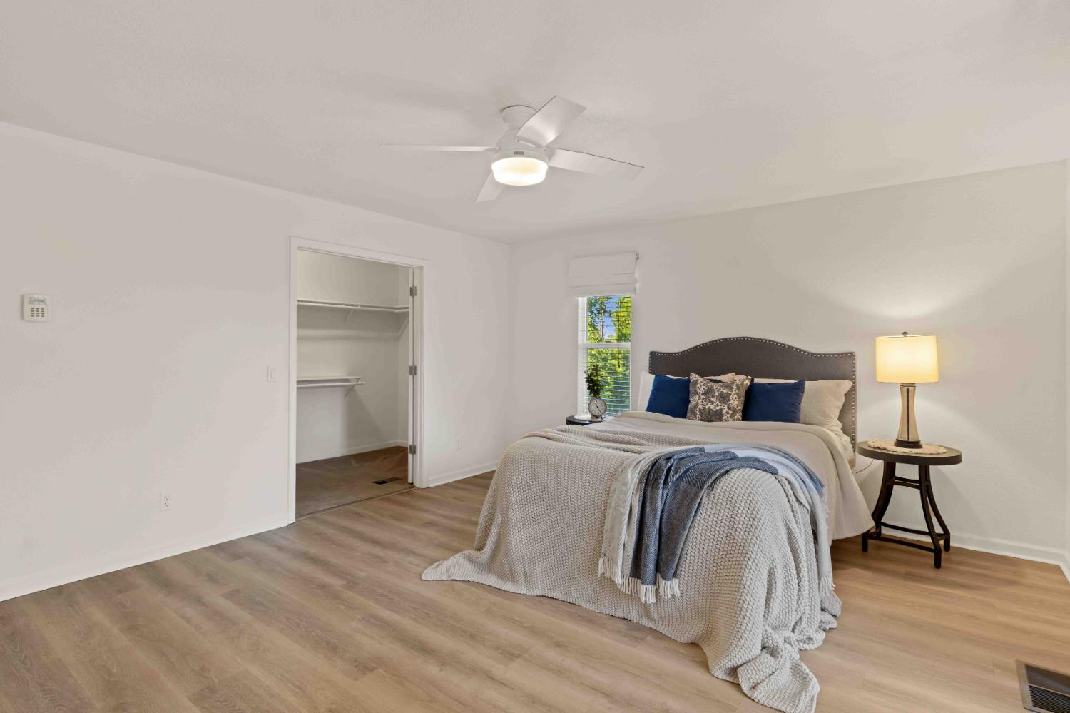 5341 Puerta Del Sol Road Camino, CA 95709 - Photo 13 of 31 a spacious bedroom with a bed and a lamp