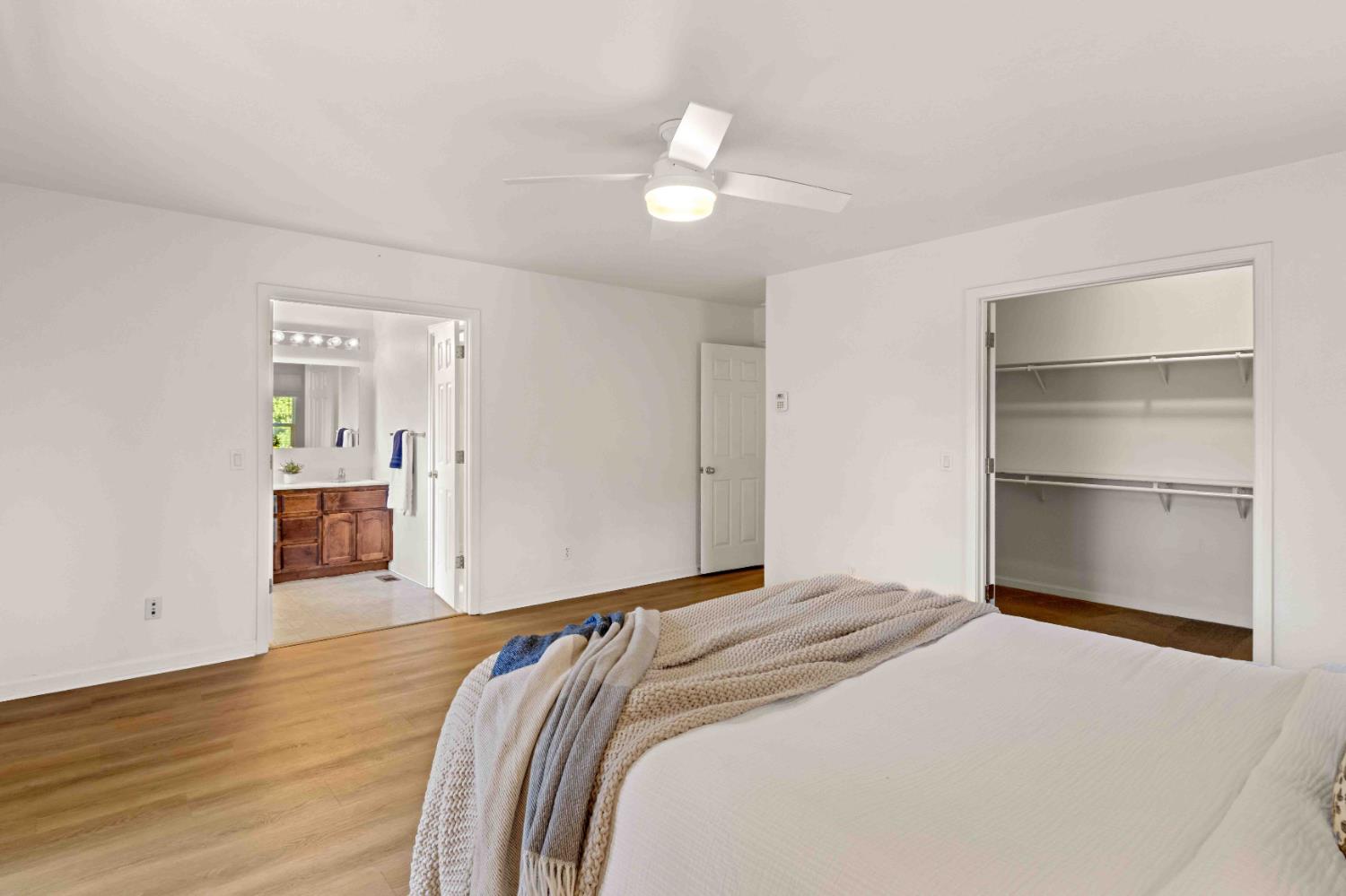 5341 Puerta Del Sol Road Camino, CA 95709 - Photo 14 of 31 a bedroom with a bed and a chandelier