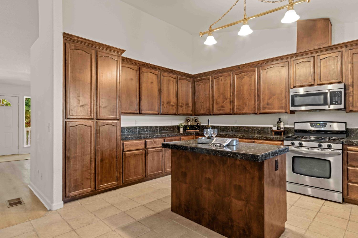5341 Puerta Del Sol Road Camino, CA 95709 - Photo 9 of 31 a kitchen with stainless steel appliances granite countertop a stove top oven sink and cabinets